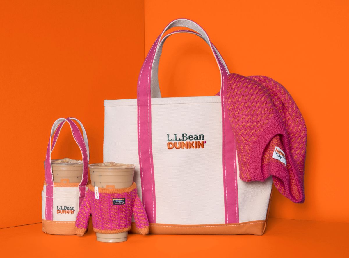 An L.L.Bean x Dunkin' canvas tote bag, a matching mini tote, two iced coffee cups with knit sleeves, and a pink and orange knit hat on orange for Dunkin L.L.Bean fall collaboration