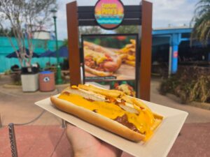 Hot dog with chili and cheese show in front of Captain Pete's Hot Dogs at SeaWorld Orlando