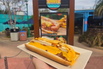 Hot dog with chili and cheese show in front of Captain Pete's Hot Dogs at SeaWorld Orlando