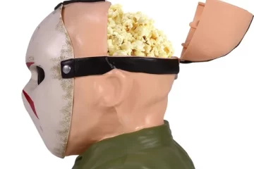 Side profile view of Jason Voorhees Friday the 13th popcorn bucket with open head lid filled with popcorn