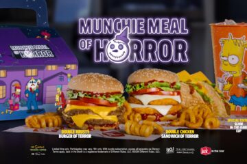 A Jack in the Box Munchie Meal of Horror featuring two burgers, tacos, curly fries, and a Simpsons-themed cup in a purple branded cardboard box.