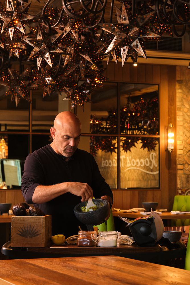 Rocco's Tacos Orlando Guacamole promotional image showing guacamole being made