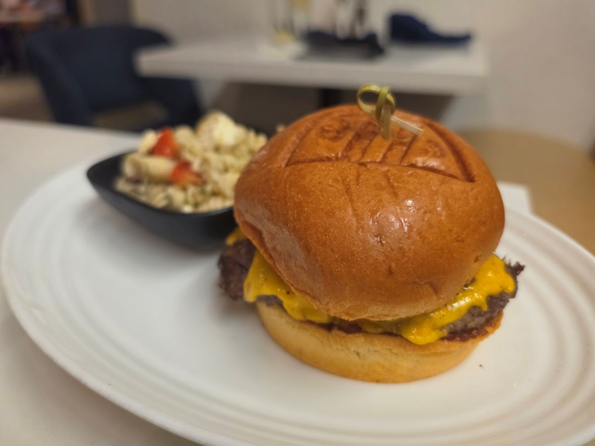 Close-up view of the signature Stack Burger on a toasted brioche bun for a Steakhouse 71 lunch review.