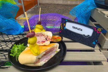 Tripleta Sandwich shown on a seaside-themed display for the Taste of Terror menu at Howl-O-Scream Orlando