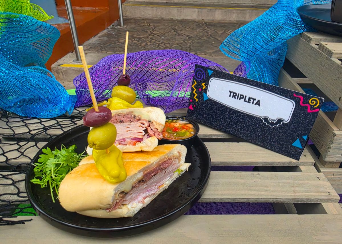 Tripleta Sandwich shown on a seaside-themed display for the Taste of Terror menu at Howl-O-Scream Orlando