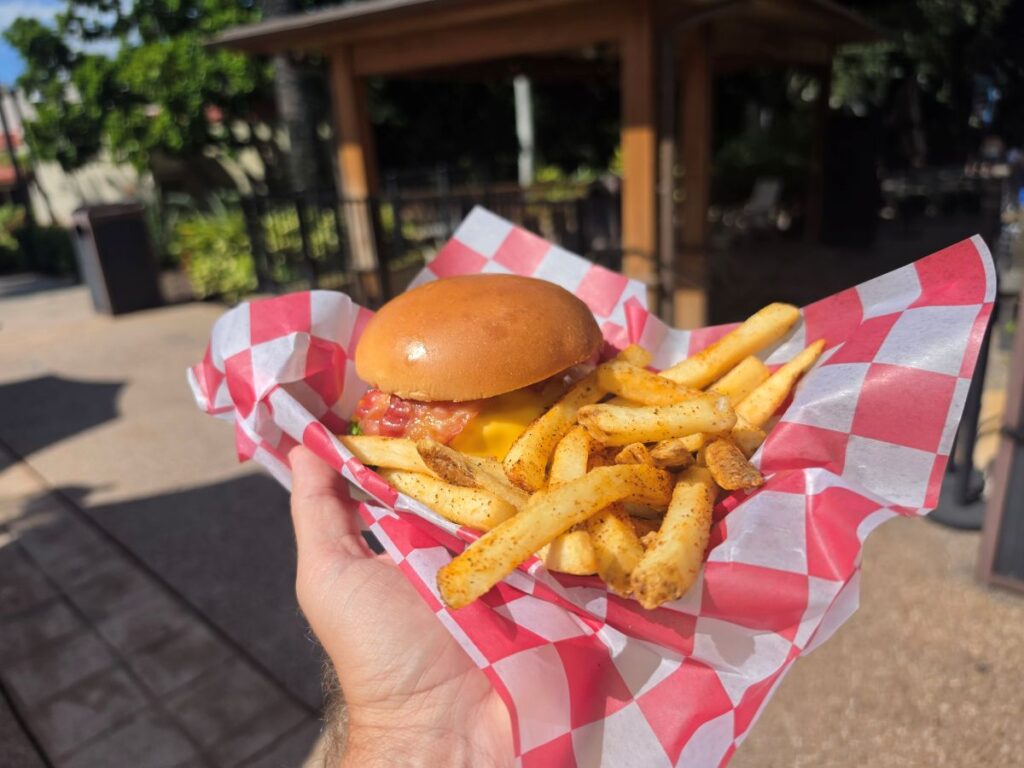Zagora Cafe Double Cheeseburger held showing the fries and burger