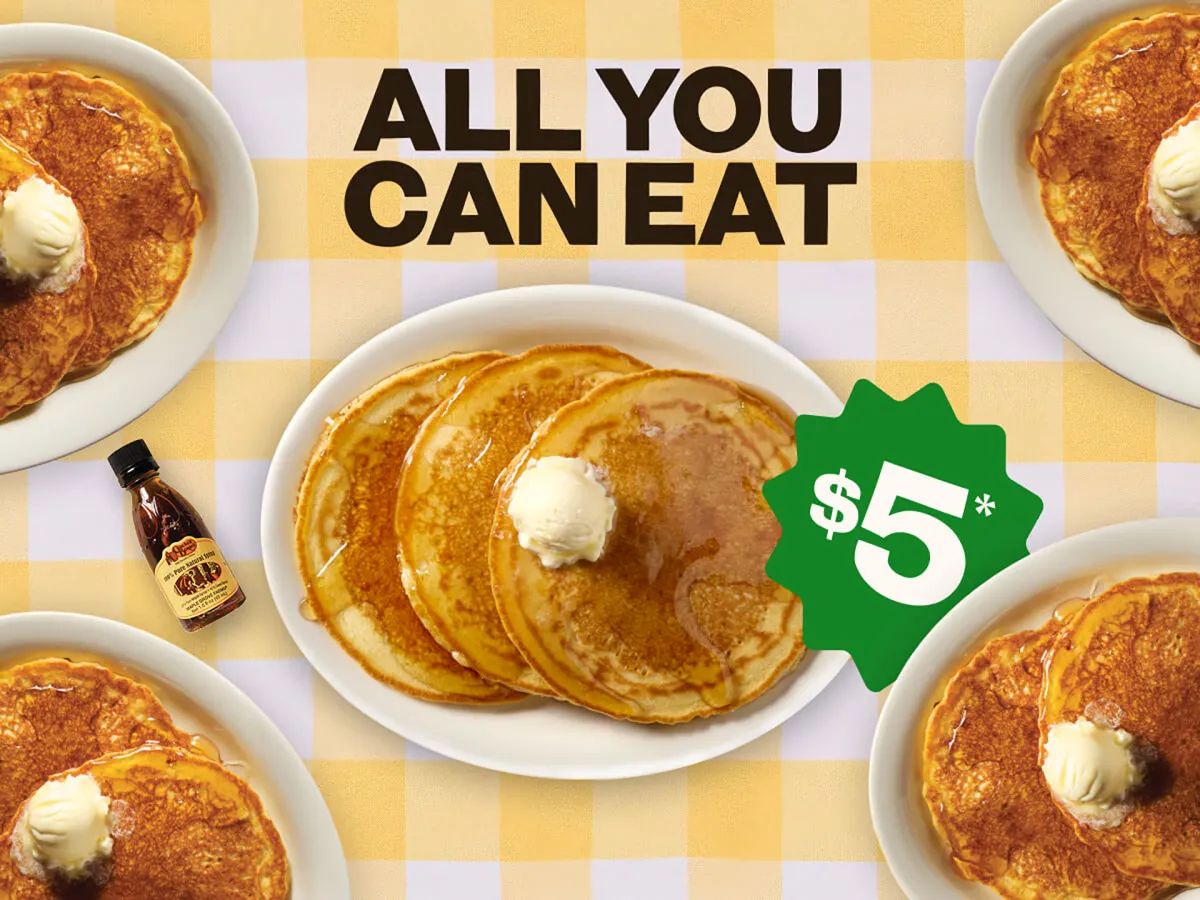Plates of golden pancakes topped with butter on a yellow checkered tablecloth, with text reading ALL YOU CAN EAT and a green starburst label for $5 - Cracker Barrel pancake deal.