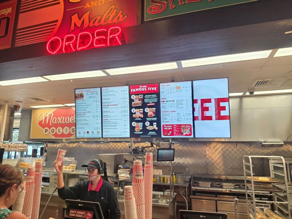 Interior of restaurant with menu shown in background