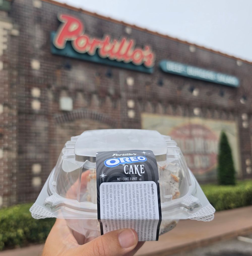 Portillo's Oreo Cake is shown in a plastic container in front of the restaurant's exterior