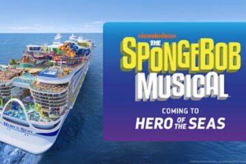 A large cruise ship sails on the ocean next to a blue sign announcing The SpongeBob Musical is coming to the Hero of the Seas cruise ship vessel.